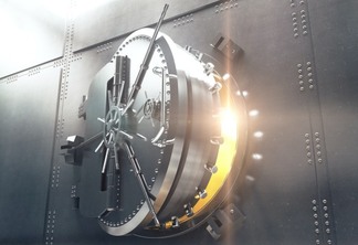 Closeup of an open bank vault door with golden light peeking from inside. 3D Render